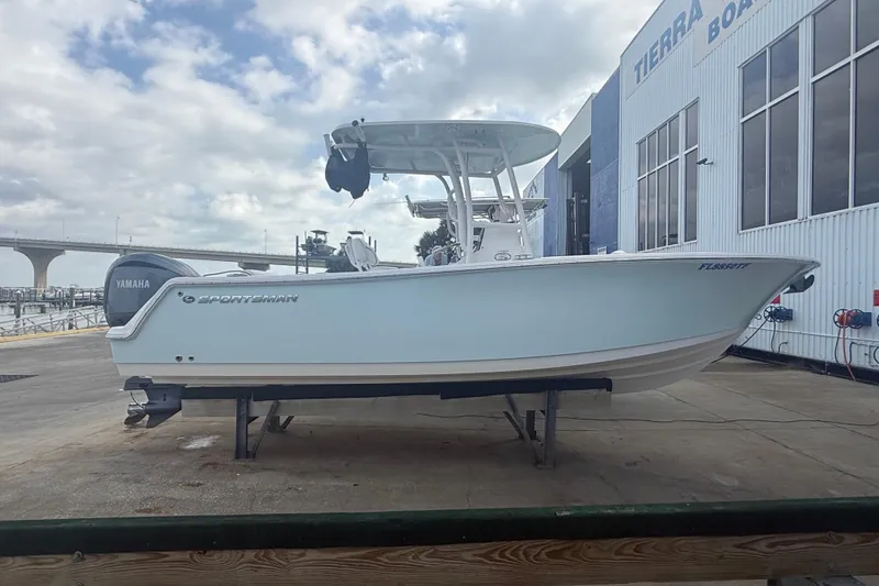 The Image of 2022 Sportsman Open 232 Center Console boat on a dock, with Yamaha engine. - 0