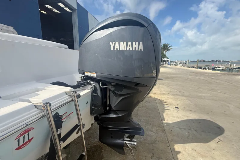 Slide: The Image of 2022 Sportsman Open 232 Center Console with Yamaha outboard motor at marina. - 12