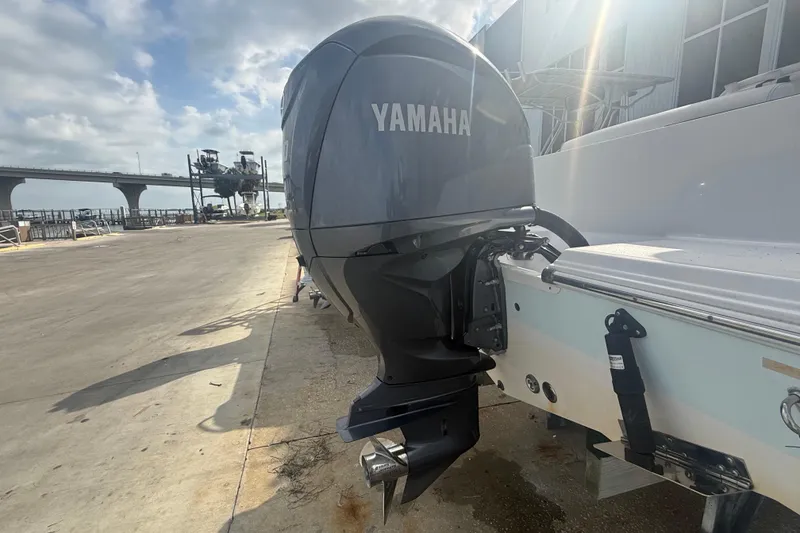 Slide: The Image of 2022 Sportsman Open 232 Center Console with Yamaha outboard motor at dockside. - 14