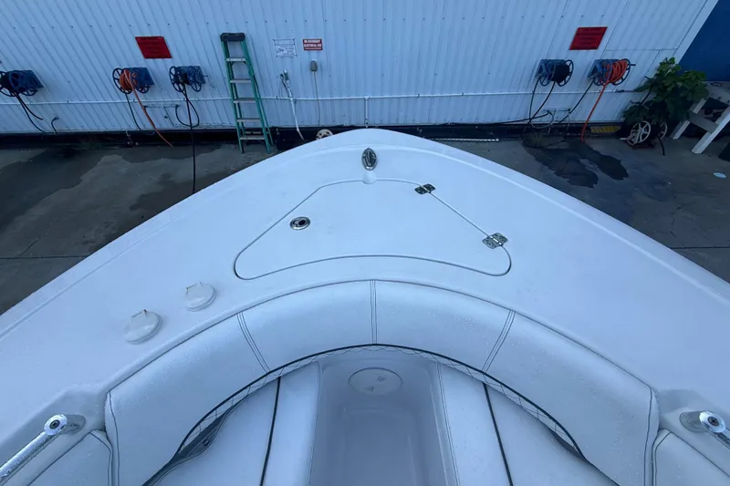 Slide: The Image of 2022 Sportsman Open 232 Center Console boat bow with seating and storage compartments. - 25