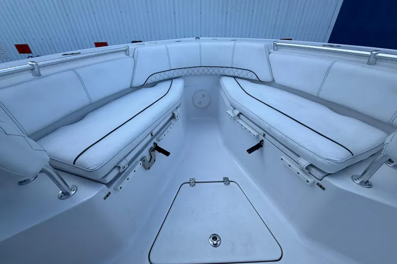 Slide: The Image of 2022 Sportsman Open 232 Center Console boat interior with white cushioned seating. - 29