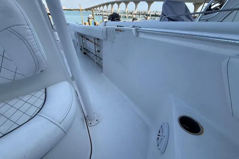 Slide: The Image of 2022 Sportsman Open 232 Center Console boat interior with seating and ocean view. - 32