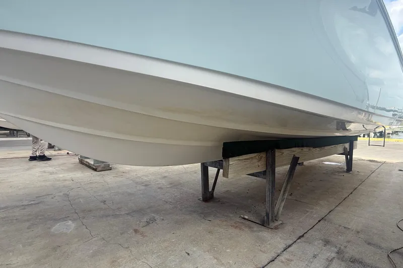 Slide: The Image of 2022 Sportsman Open 232 Center Console boat on a stand, viewed from below. - 9