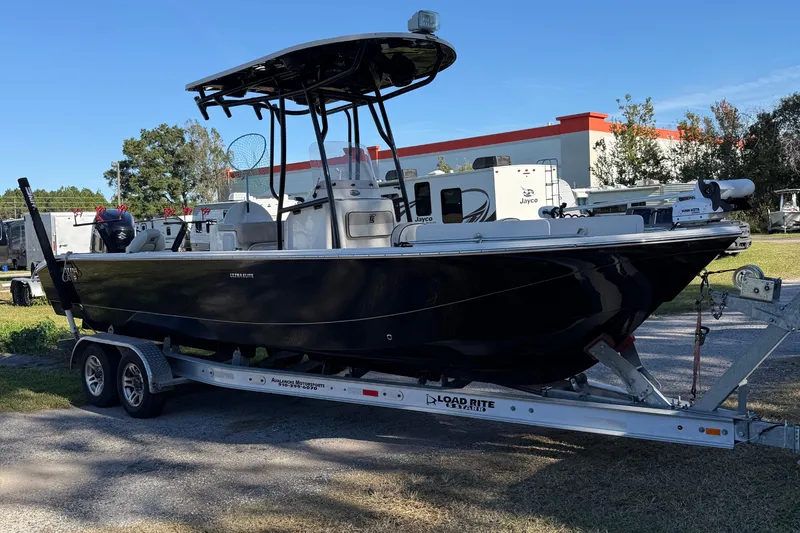 Slide: The Image of 2021 Carolina Skiff 26 Ultra Elite boat on trailer, parked outdoors. - 1
