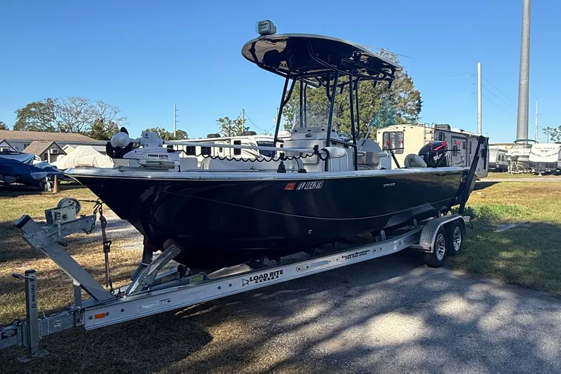 Slide: The Image of 2021 Carolina Skiff 26 Ultra Elite boat on trailer, parked outdoors. - 2