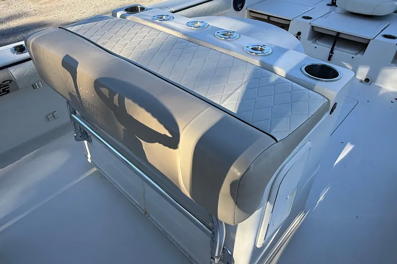 Slide: The Image of 2021 Carolina Skiff 26 Ultra Elite boat interior with cushioned seating and cup holders. - 51