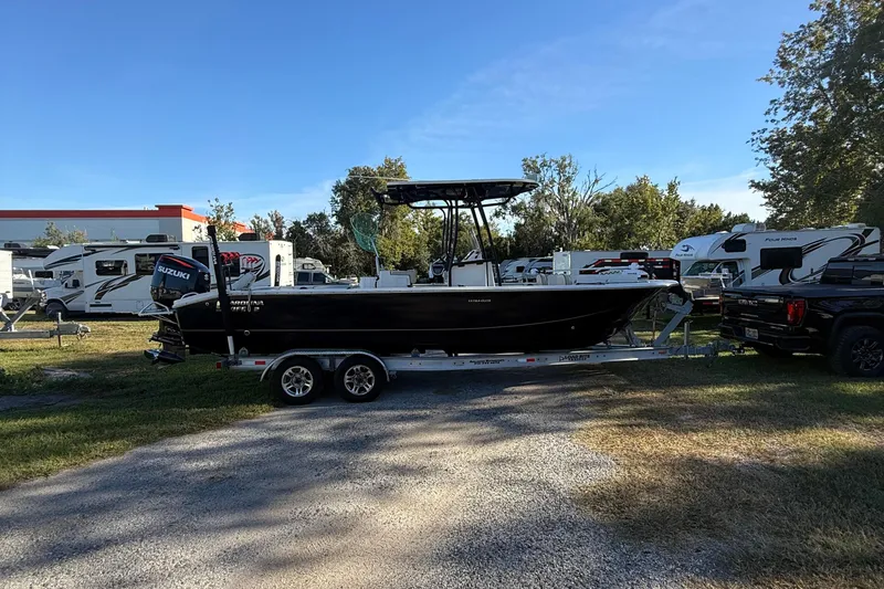 Slide: The Image of 2021 Carolina Skiff 26 Ultra Elite boat on trailer, parked outdoors near RVs. - 7