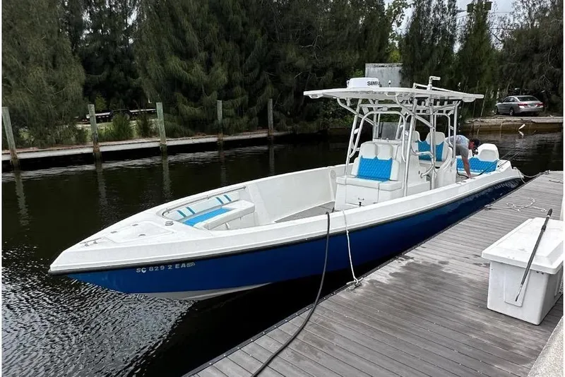 The Image of 2021 Custom Infusion 34 CC boat docked on a calm waterway. - 0