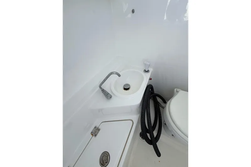 Slide: The Image of Boat bathroom with sink, faucet, and coiled hose on Custom Infusion 34 CC, 2021 model. - 14