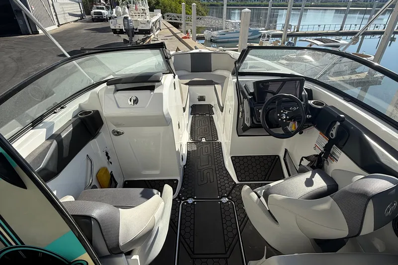 Slide: The Image of Interior of a 2021 Scarab 255 ID boat, featuring modern seating and controls. - 7