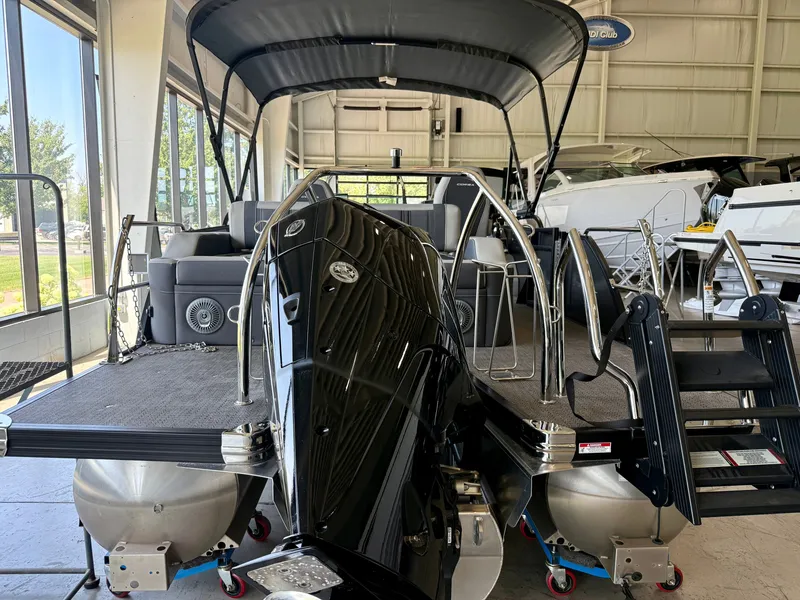 Slide: The Image of The image shows a 2025 Barletta Corsa 23UC pontoon boat in a showroom. - 30