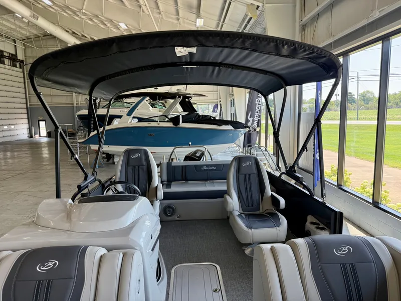 Slide: The Image of 2025 Barletta Corsa 23UC in a showroom with luxurious seating and canopy. - 20