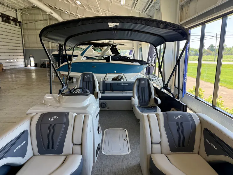 Slide: The Image of The image shows the interior of a 2025 Barletta Corsa 23UC with gray seating and a black canopy. - 17
