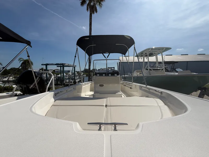 Slide: The Image of The image shows a Boston Whaler 170 Montauk boat with a sun-shading bimini top. - 6