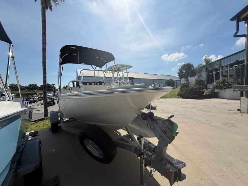 Slide: The Image of A 2027 Boston Whaler 170 Montauk on a trailer in a sunny outdoor setting. - 1