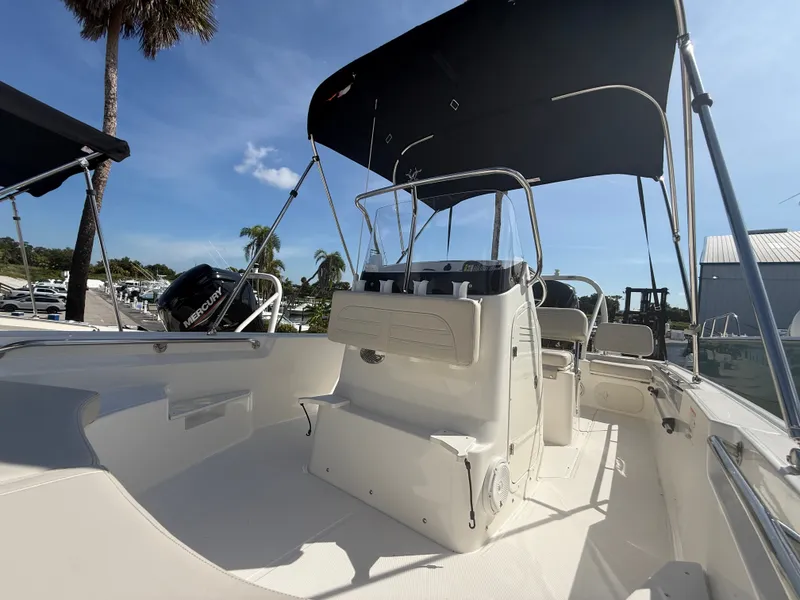 Slide: The Image of The image shows a 2027 Boston Whaler 170 Montauk boat with a simple white deck and black sunshade. - 8
