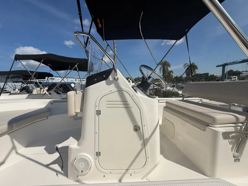 Slide: The Image of The image shows the cockpit of a Boston Whaler 170 Montauk with a helm and seating area. - 9