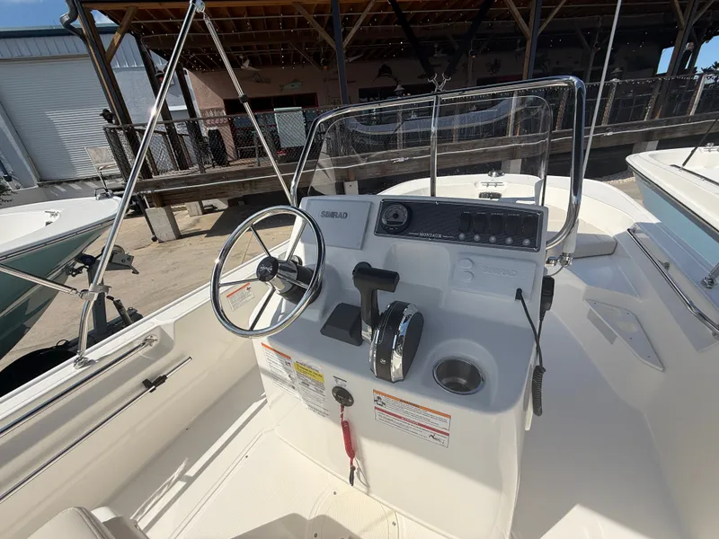 Slide: The Image of The image shows the helm of a 2027 Boston Whaler 170 Montauk boat. - 12