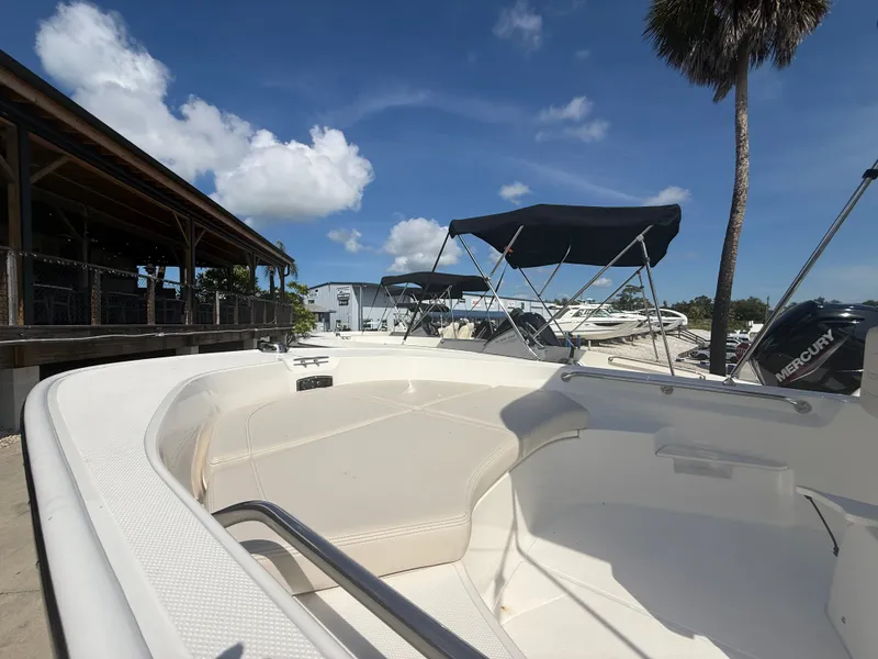 Slide: The Image of The image shows the deck of a 2027 Boston Whaler 170 Montauk, with clear blue skies in the background. - 7