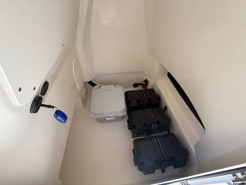 Slide: The Image of Interior of a 2027 Boston Whaler 220 Dauntless with storage space and equipment. - 21