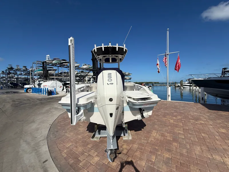 Slide: The Image of A 2027 Boston Whaler 220 Dauntless on a paved dock overlooking the water. - 4