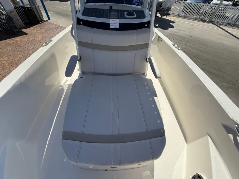Slide: The Image of The 2027 Boston Whaler 220 Dauntless features a spacious, cushioned seating area at the bow. - 12