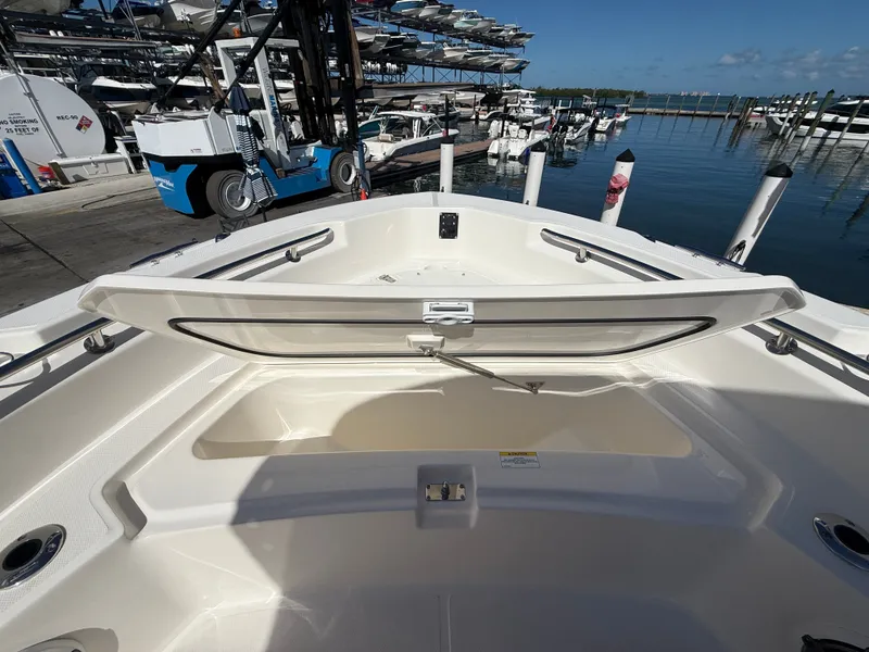 Slide: The Image of The image shows the open bow area of a Boston Whaler 220 Dauntless boat at a marina. - 11