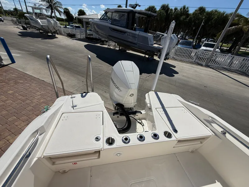 Slide: The Image of The image shows the stern of a Boston Whaler 220 Dauntless with a Mercury outboard motor. - 26