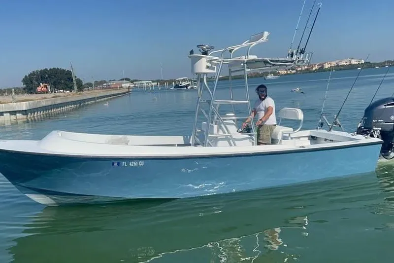 The Image of A blue Aquasport boat with a center console on calm water. - 0