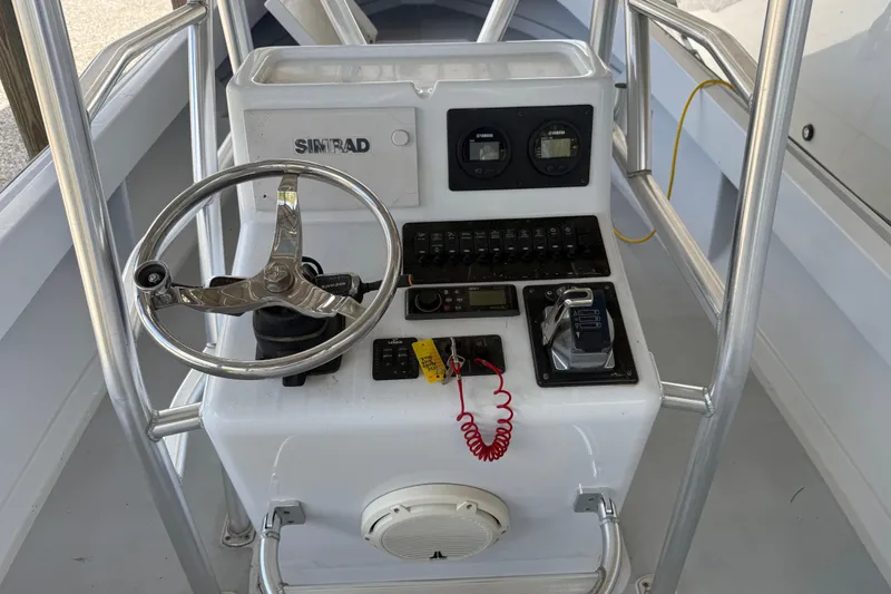 Slide: The Image of 1974 Aquasport 2400 Center Console boat dashboard with steering wheel and controls. - 17