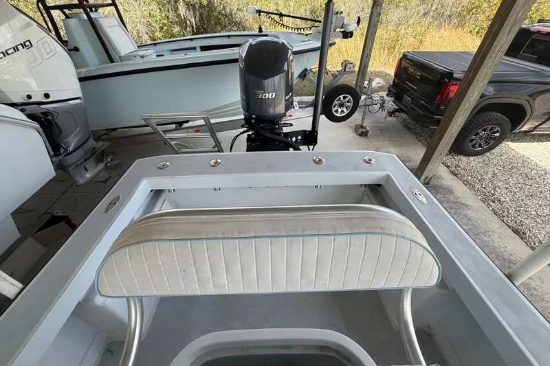 Slide: The Image of 1974 Aquasport 2400 Center Console boat with 300 horsepower engine, parked under a shelter. - 38