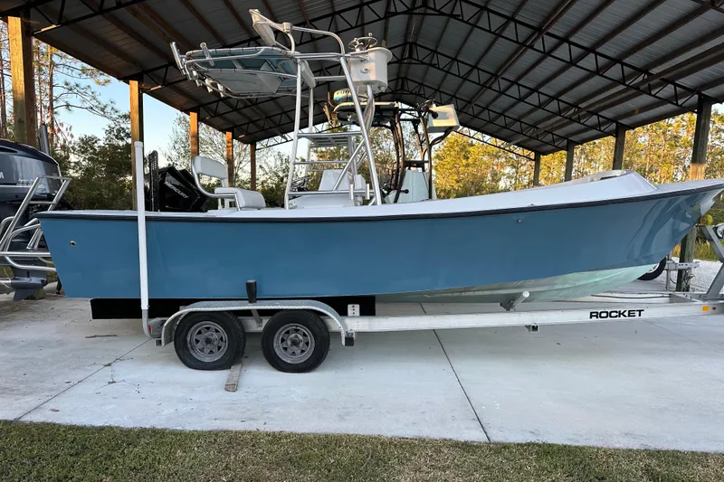 Slide: The Image of 1974 Aquasport 2400 Center Console boat on trailer under metal canopy. - 4