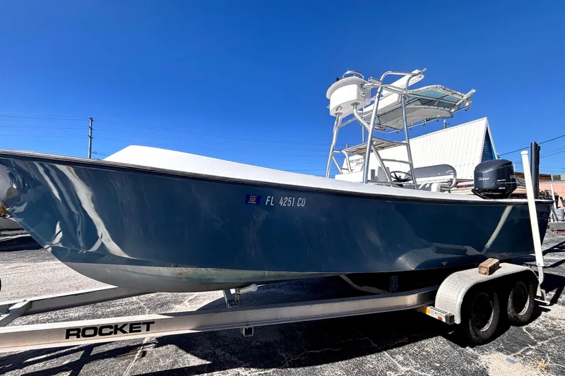 Slide: The Image of 1974 Aquasport 2400 Center Console boat on trailer under clear blue sky. - 5