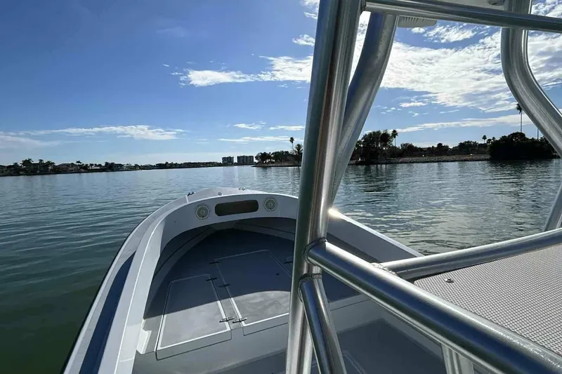 Slide: The Image of A boat on calm water with a blue sky and some clouds in the background. - 7