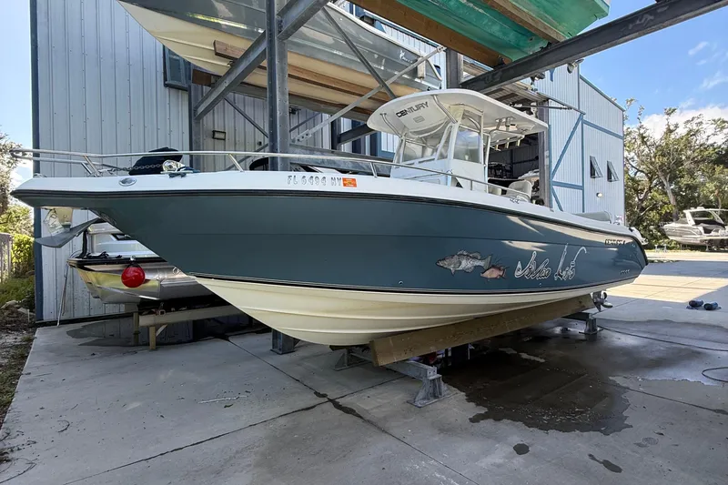Slide: The Image of 2008 Century 2901 Center Console boat on a lift, docked at a marina. - 2