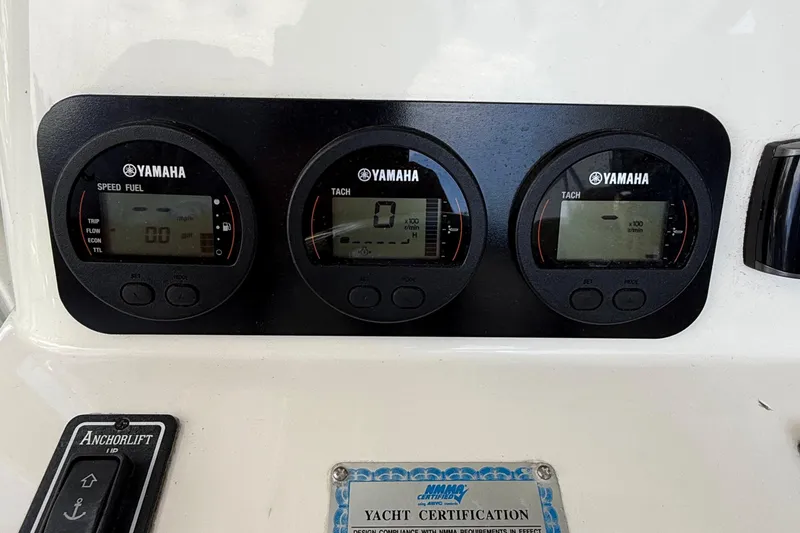 Slide: The Image of Yamaha gauges on 2008 Century 2901 Center Console boat dashboard with anchor lift control. - 30