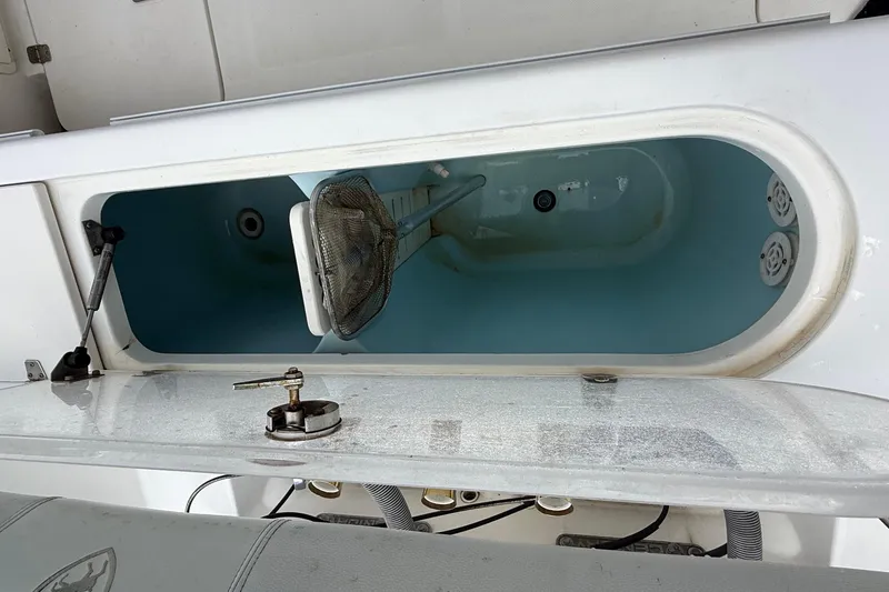 Slide: The Image of Open livewell on 2008 Century 2901 Center Console boat, featuring a net and water. - 52
