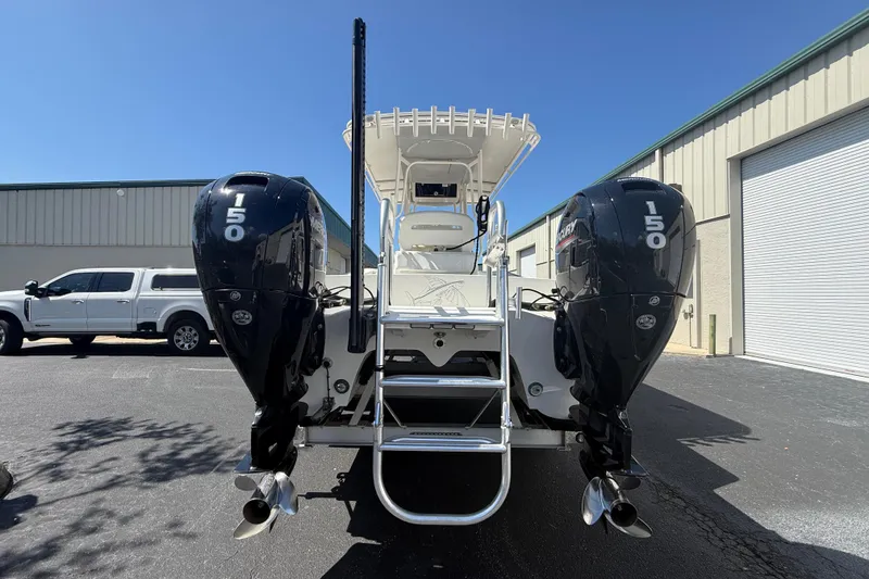 Slide: The Image of 2019 Calcutta 263 boat with dual 150 horsepower engines, parked outdoors. - 10