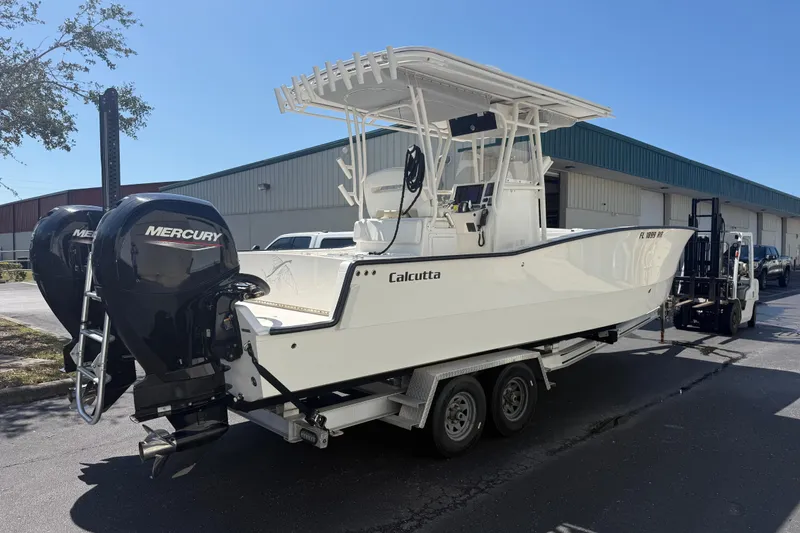 Slide: The Image of 2019 Calcutta 263 boat with dual Mercury engines on a trailer. - 19