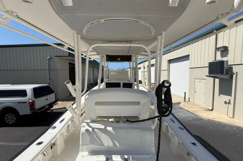 Slide: The Image of 2019 Calcutta 263 boat interior with T-top, parked near industrial buildings. - 28
