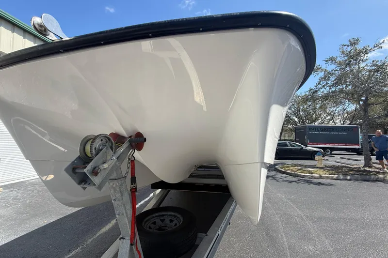 Slide: The Image of 2019 Calcutta 263 boat on trailer, parked outdoors under clear sky. - 6