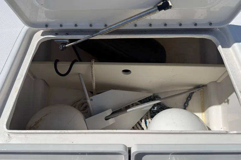 Slide: The Image of Open storage compartment on Calcutta 263 boat, containing anchor, ropes, and buoys. - 65
