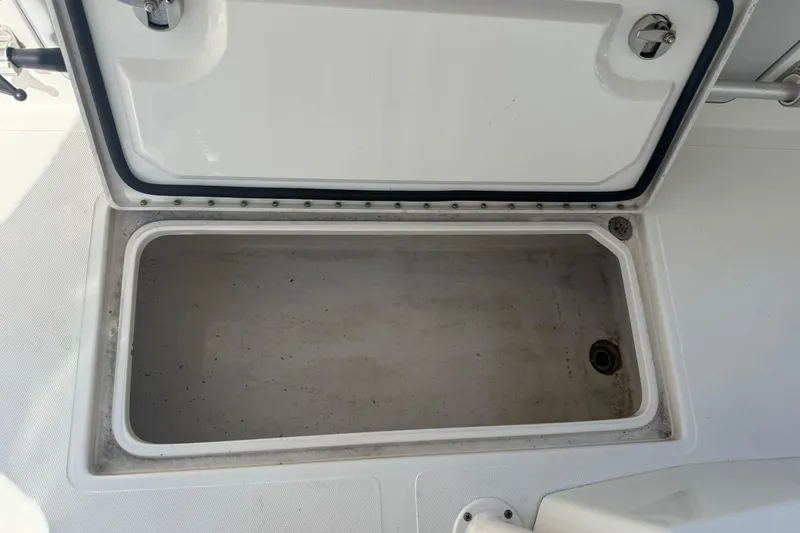 Slide: The Image of Open storage compartment on a 2019 Calcutta 263 boat, showing interior space. - 67