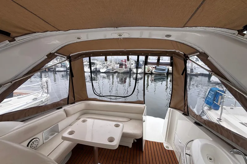 Slide: The Image of Interior view of a 2004 Larson 310 boat with marina backdrop. - 22