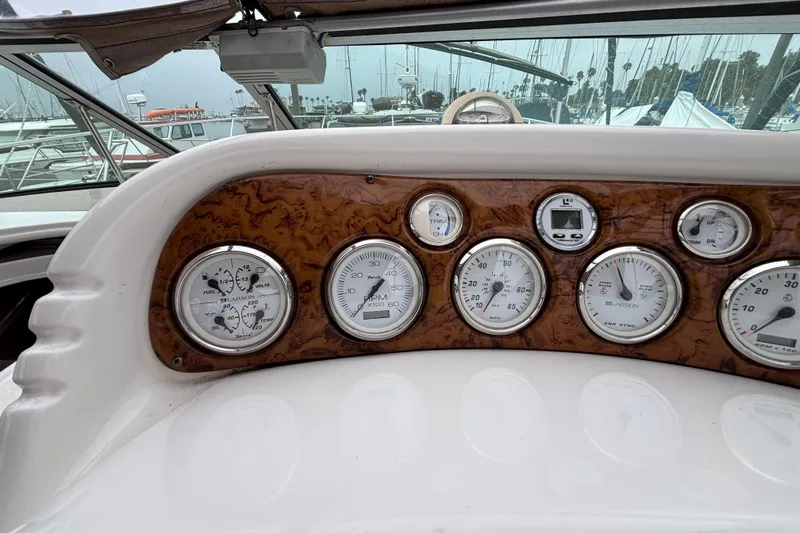 Slide: The Image of Dashboard of a 2004 Larson 310 boat with various gauges and controls. - 27