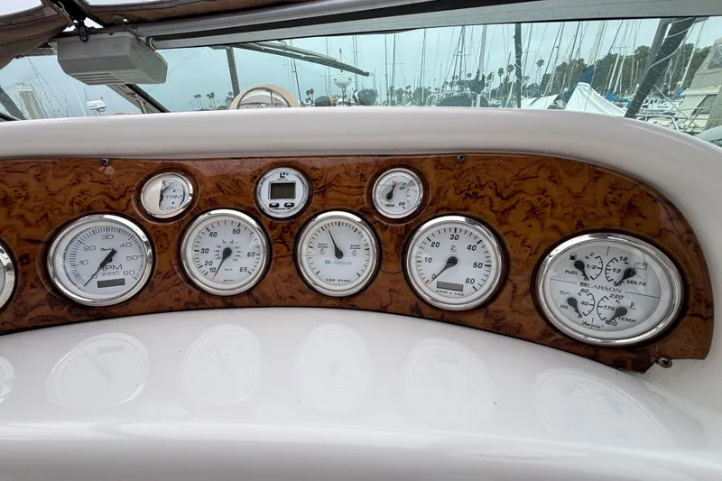 Slide: The Image of Dashboard of a 2004 Larson 310 boat with various gauges and controls. - 29