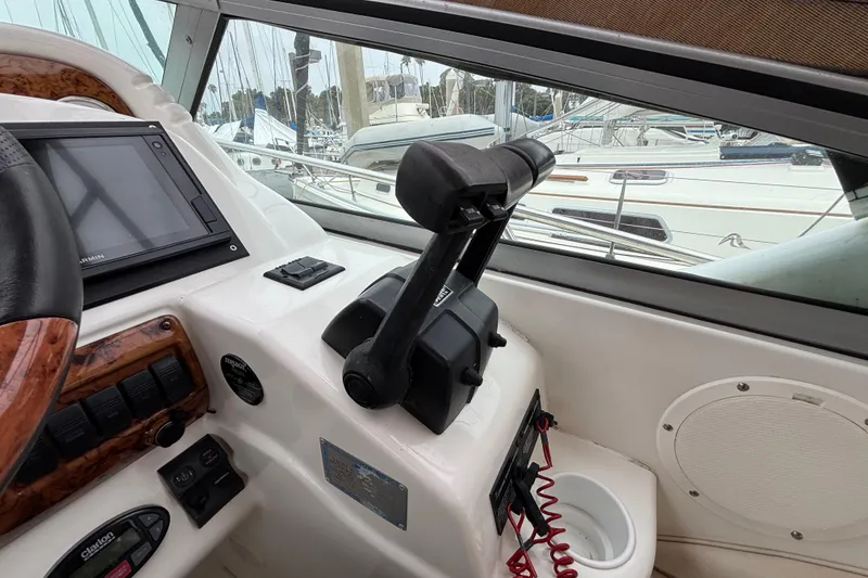 Slide: The Image of Cockpit of a 2004 Larson 310 boat with navigation controls and display. - 32