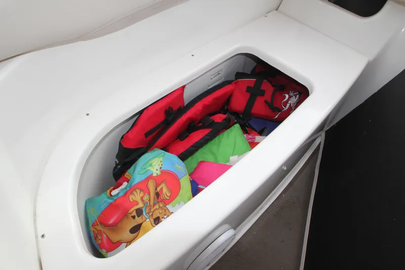 Slide: The Image of A storage compartment on a boat with life jackets and colorful cushions. - 33