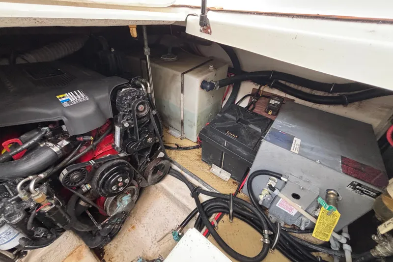 Slide: The Image of Engine compartment of a 2004 Larson 310 boat, showing engine and components. - 53