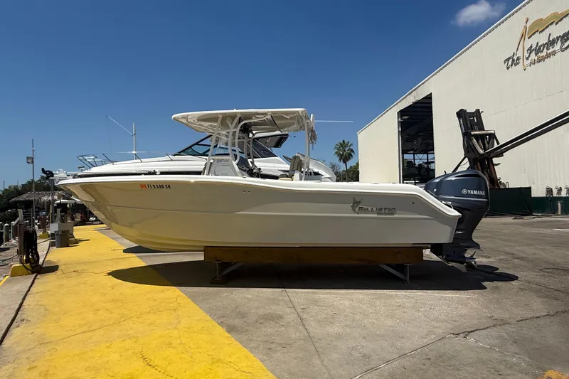 Slide: The Image of 2019 Key West Billistic 281 Center Console boat on display at a marina. - 1